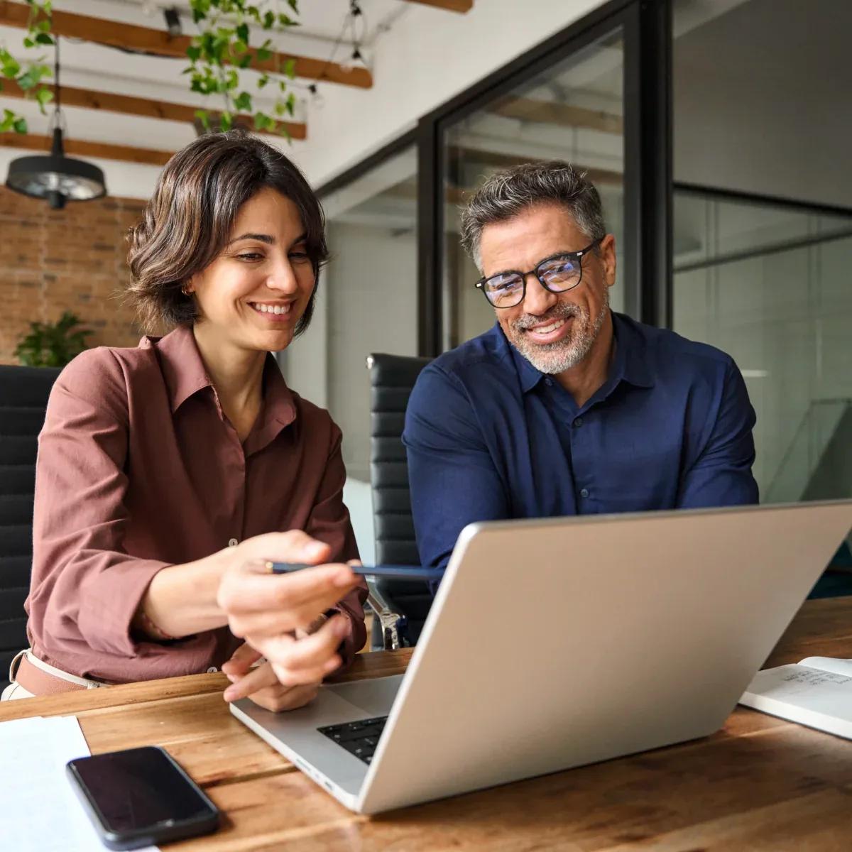 Image of two finance leaders working together using Kyriba's advanced liquidity planning tool