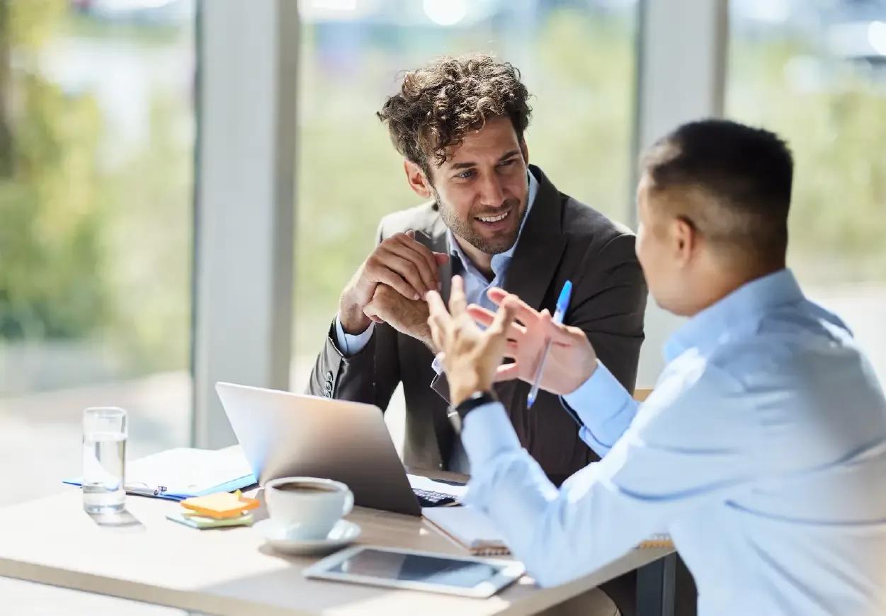 Two Kyriba customers in the banking industry having a meeting together