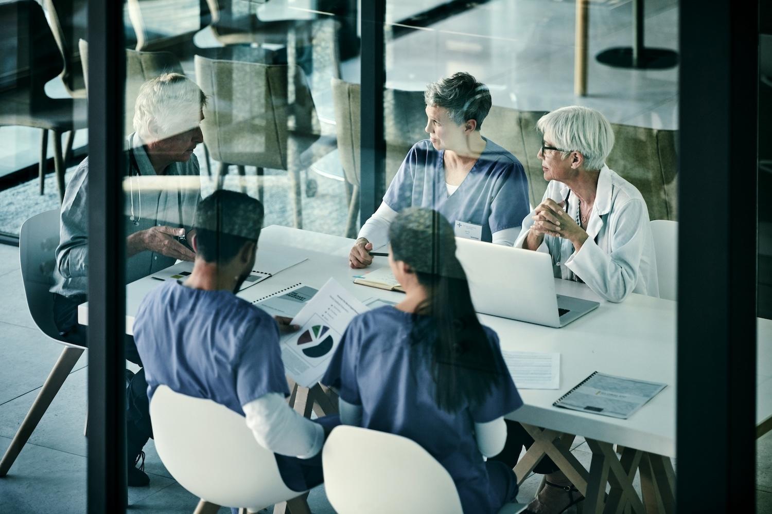 Group of healthcare professionals discussing finance topics