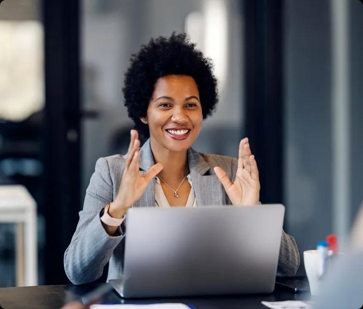 Image of a finance leader using Kyriba on her laptop during a meeting