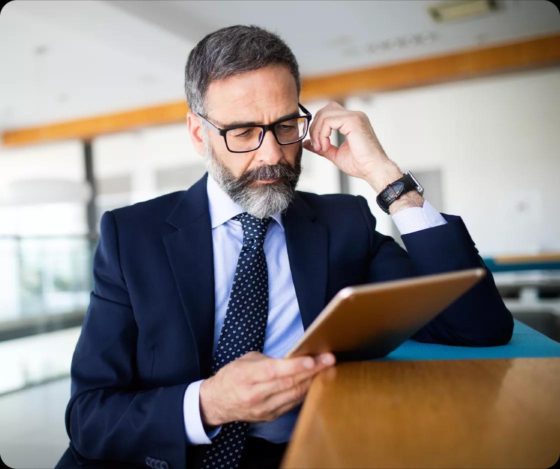 Image of a finance leader working on his tablet