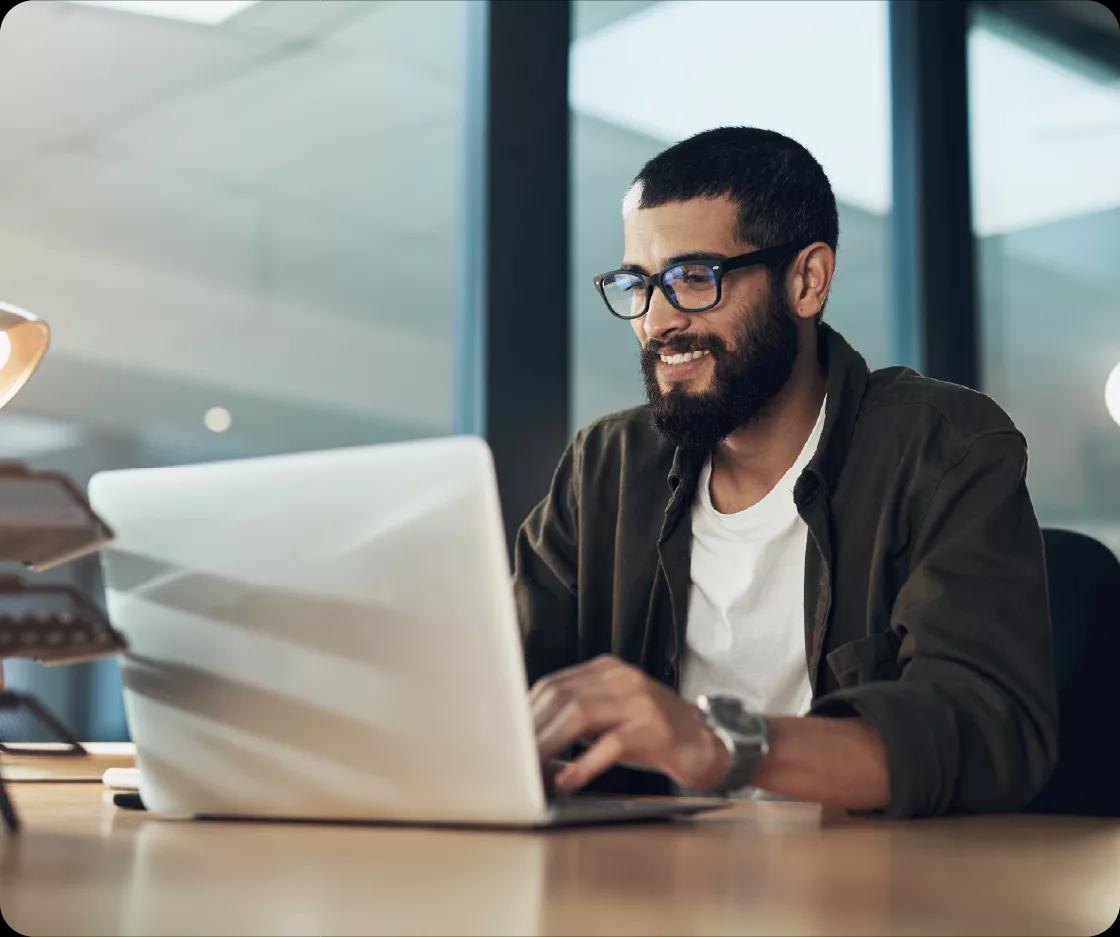 Treasury manager Kyriba customer in the banking industry working on his laptop