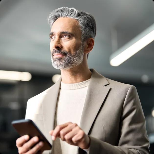 Image of a finance leader checking in on performance from his phone