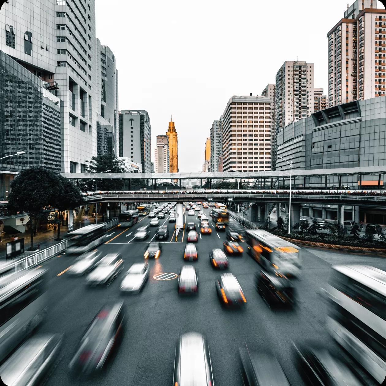 Image of a busy street with fast moving cars